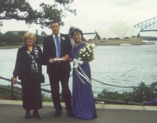Celebrant with a couple with Opera House background